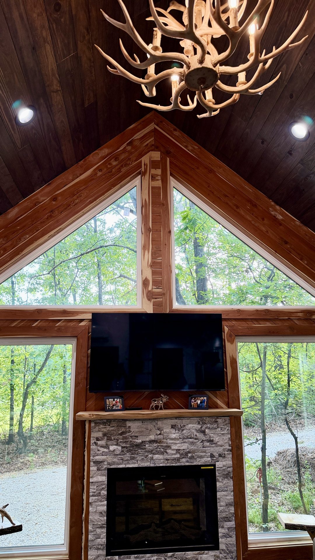 Cozy interior with stone fireplace and forest-view windows